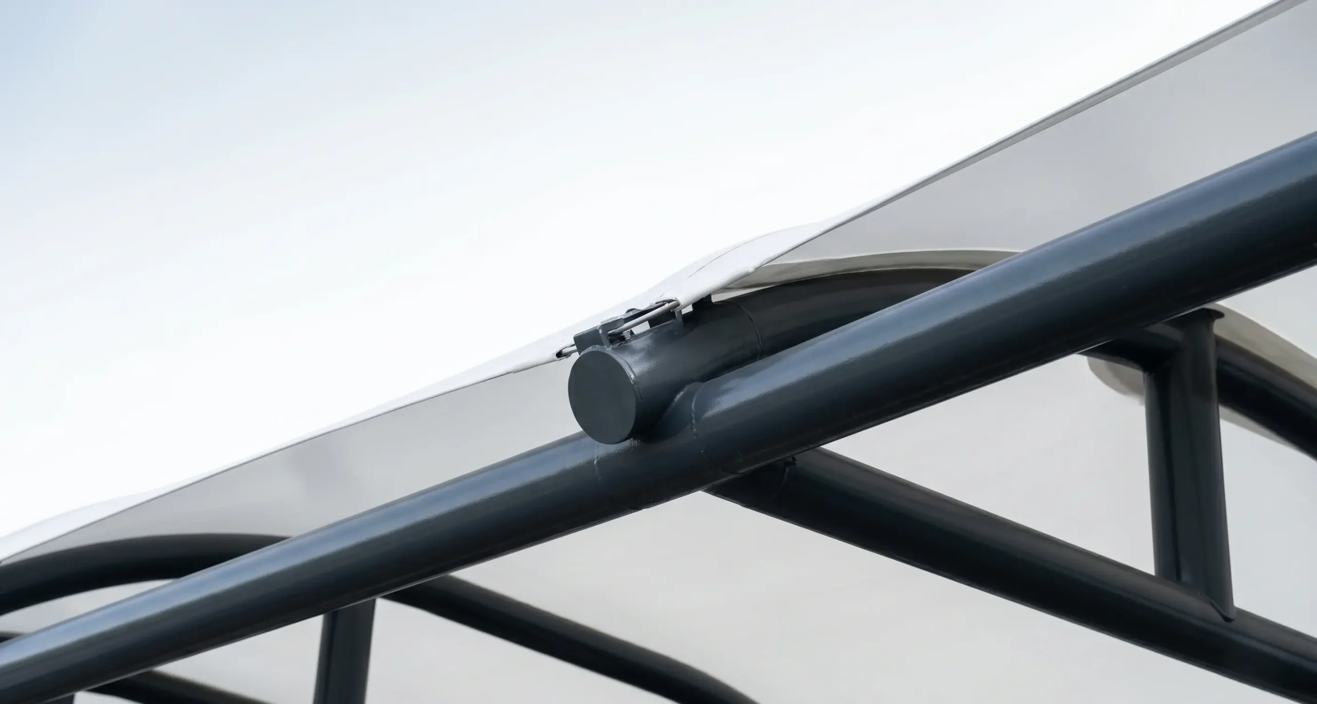 Heavy-duty commercial walkway showing the robust tubular steel framework and precise fabric tensioning.